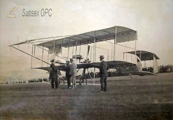 Image of Biplane in a Field - Large Crowd