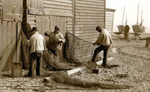 Image of Hastings - Fishermen repairing nets