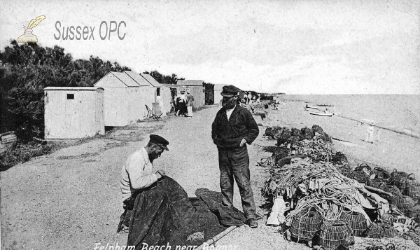 Image of Felpham - Fishermen repairing nets on the beach